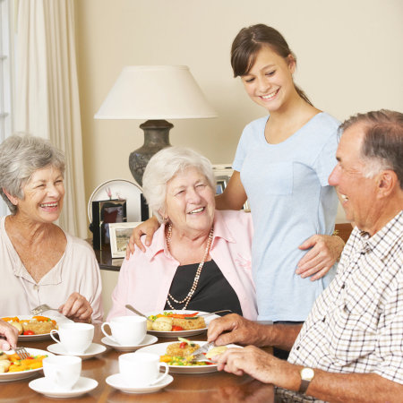 caregiver and her three old patients eating